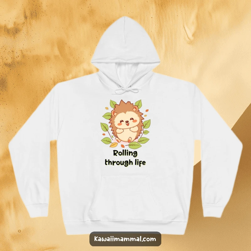 Funny Hedgehog Hoodie: Plush kawaii hedgehog enjoying a gleeful roll amidst vibrant autumn leaves, capturing pure, cozy happiness.